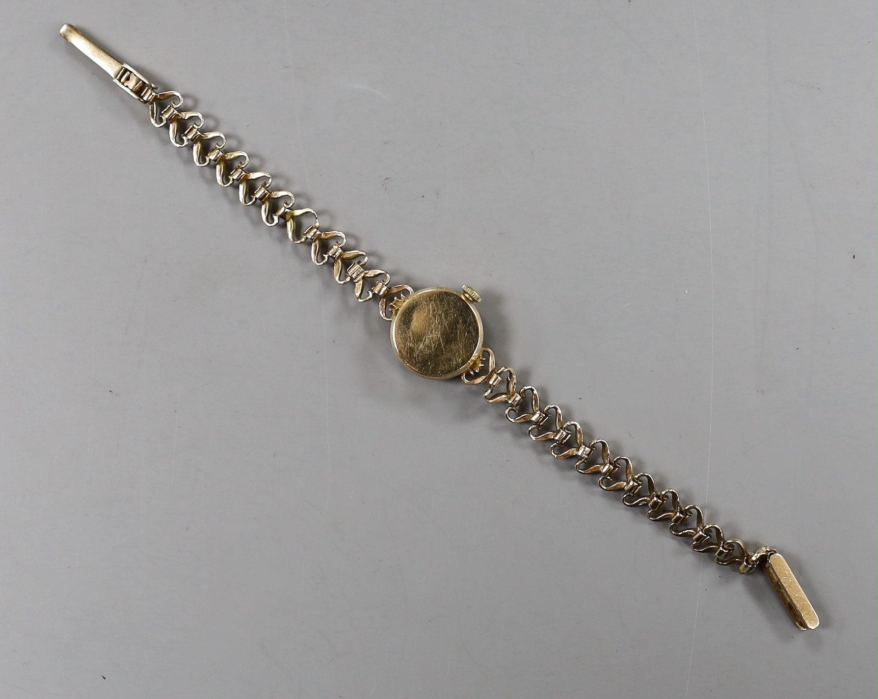 A lady's 9ct gold Accurist manual wind wrist watch, on a 9ct gold bracelet, overall 17.8cm, gross weight 14.1 grams.